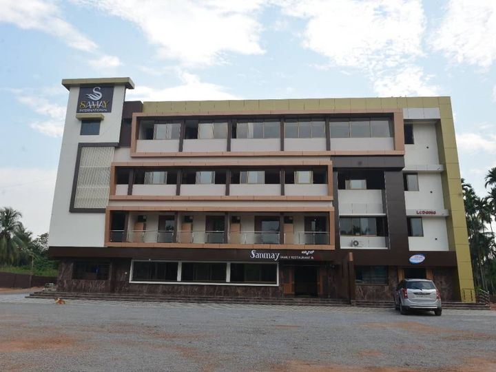 The four-storey Hotel Samay International building with balconies, seen across the open ground in front
