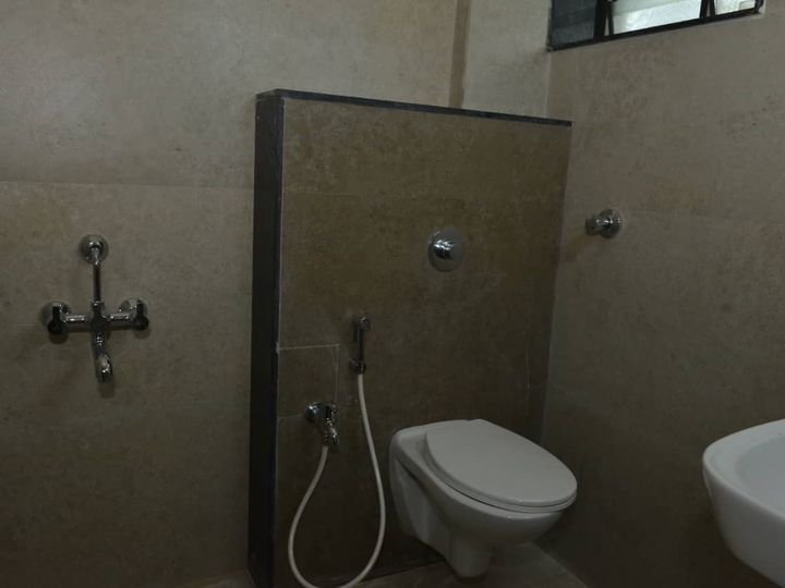 Bathroom with a Western toilet, hand shower, shower mixer and washbasin