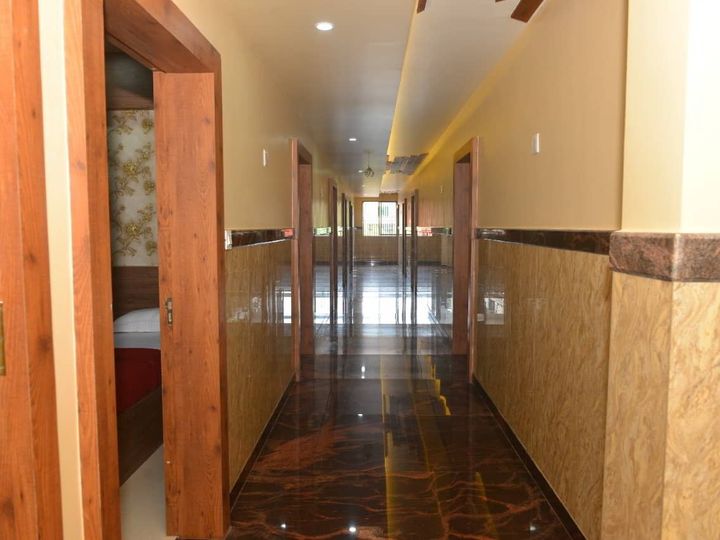 Long corridor with a polished floor and room doors along one side